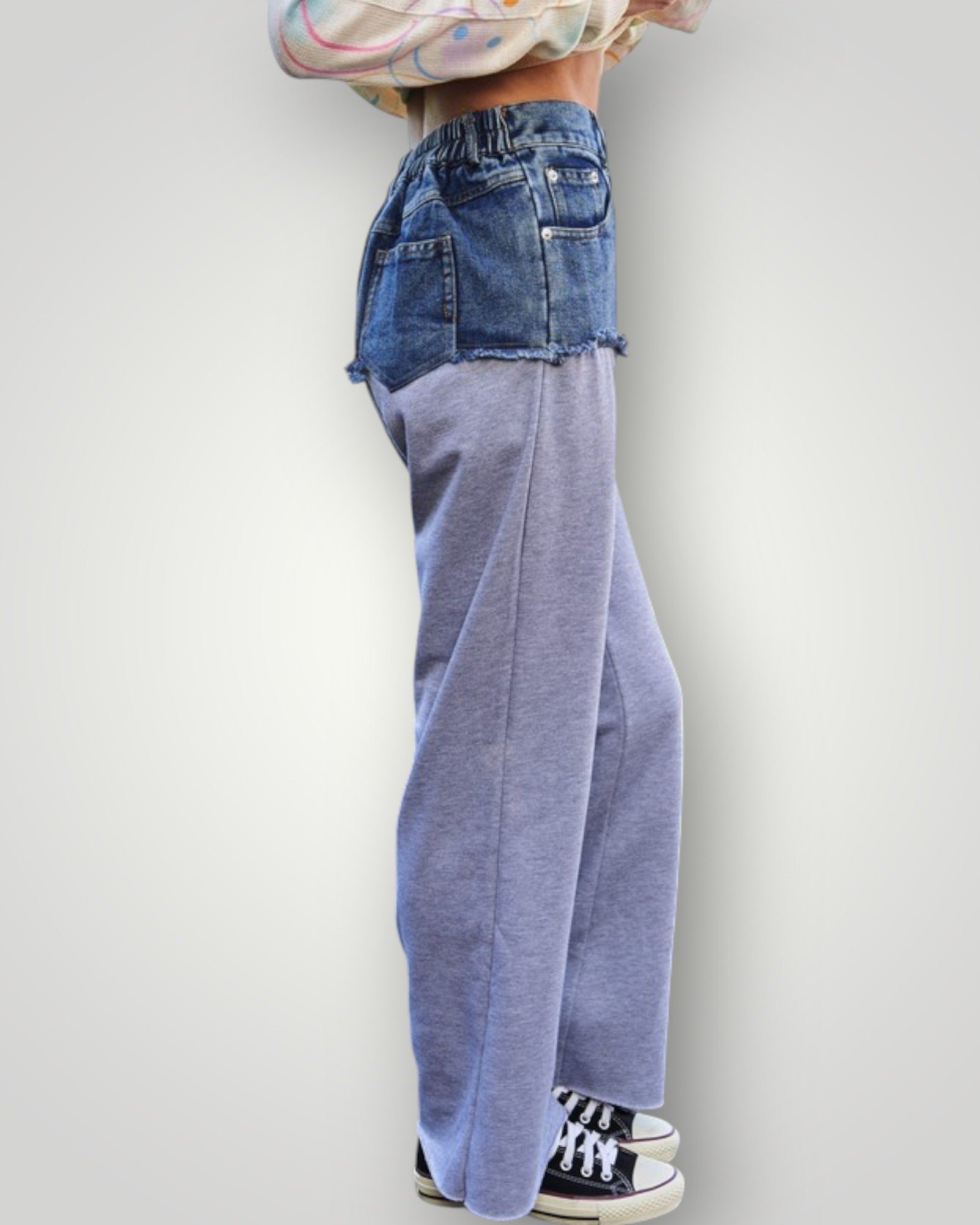 Person wearing a denim jacket and blue pants on a white background