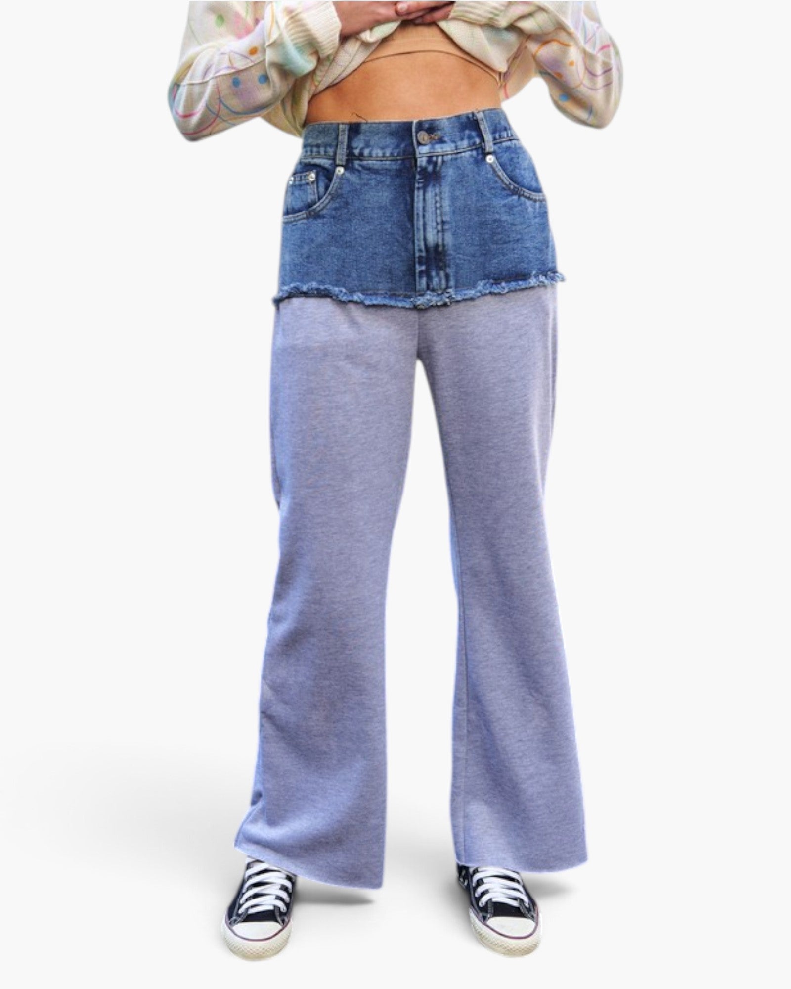 A model wearing a fashion outfit consisting of a high-waisted denim mini skirt paired with wide-leg heathered light blue sweatpants, styled with a tie-dye crop top and black sneakers against a plain white background.