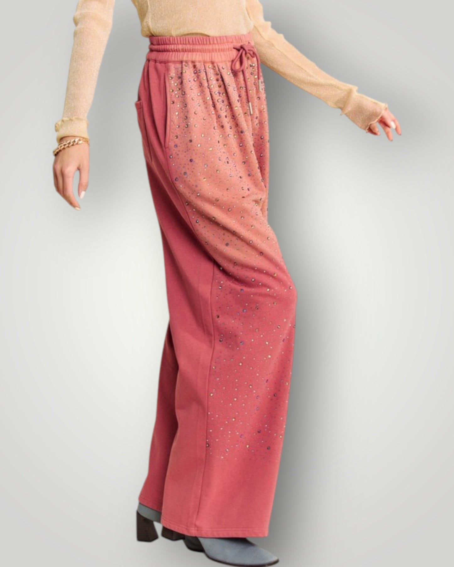 Pink pants worn by a person on a light gray background