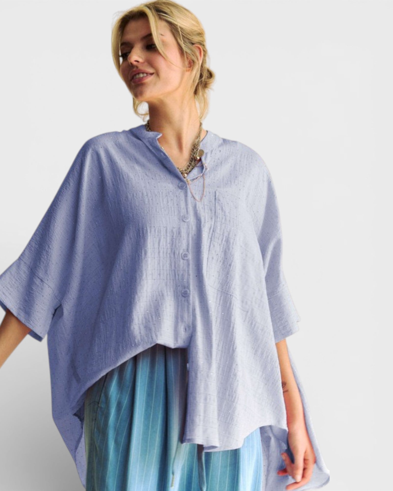 Woman wearing a light blue shirt with a white background