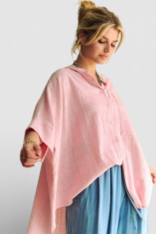 Woman wearing a pink top and blue skirt against a white background