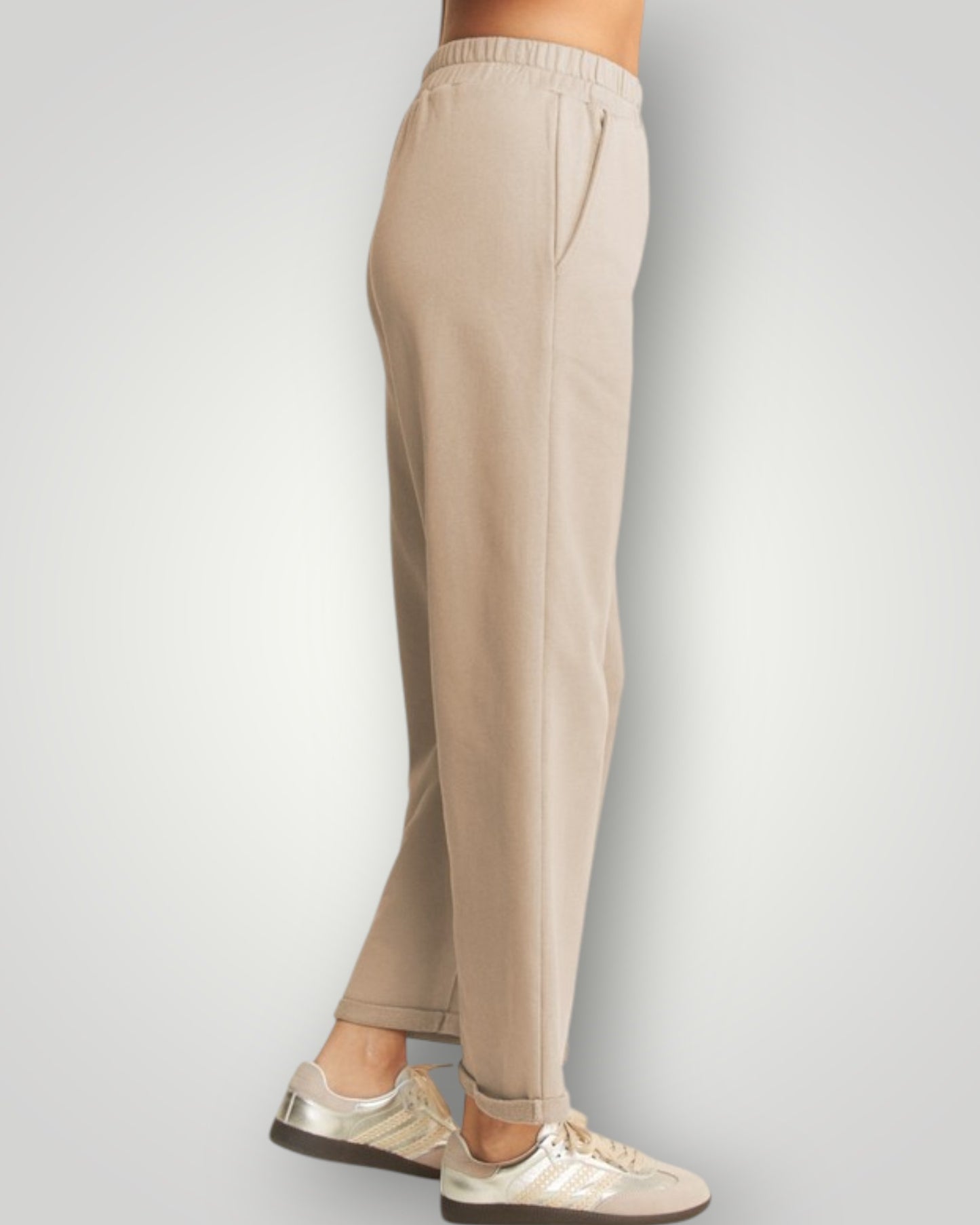 Beige pants worn by a person on a light gray background