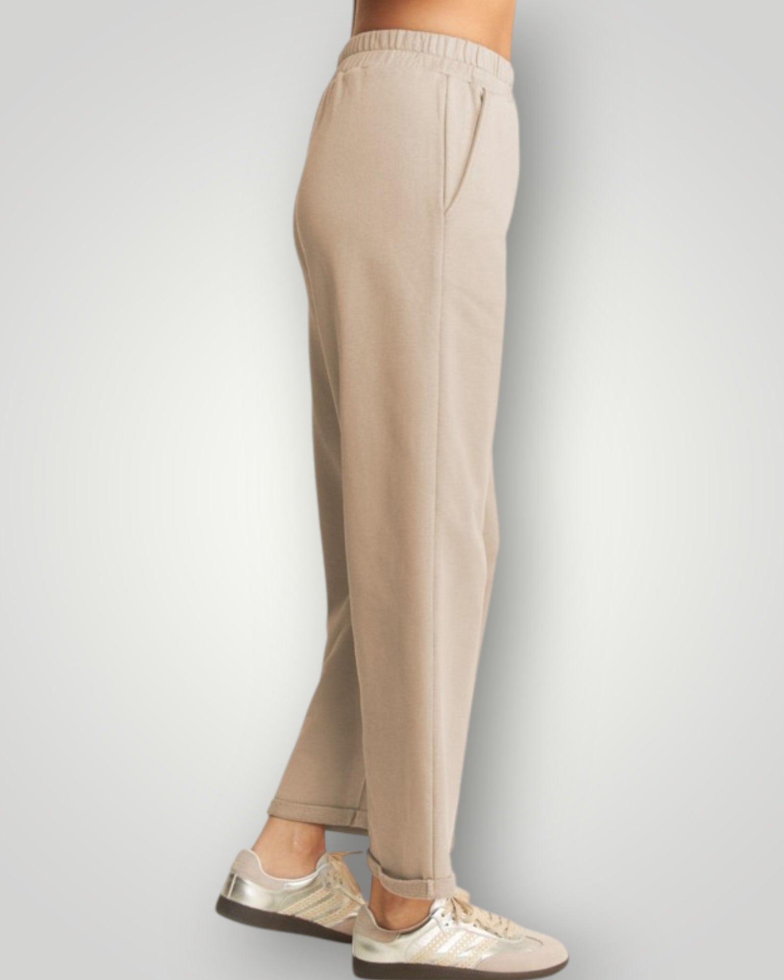 Beige pants worn by a person on a light gray background