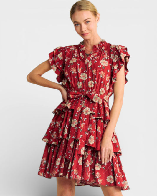 Woman wearing a red floral dress on a white background