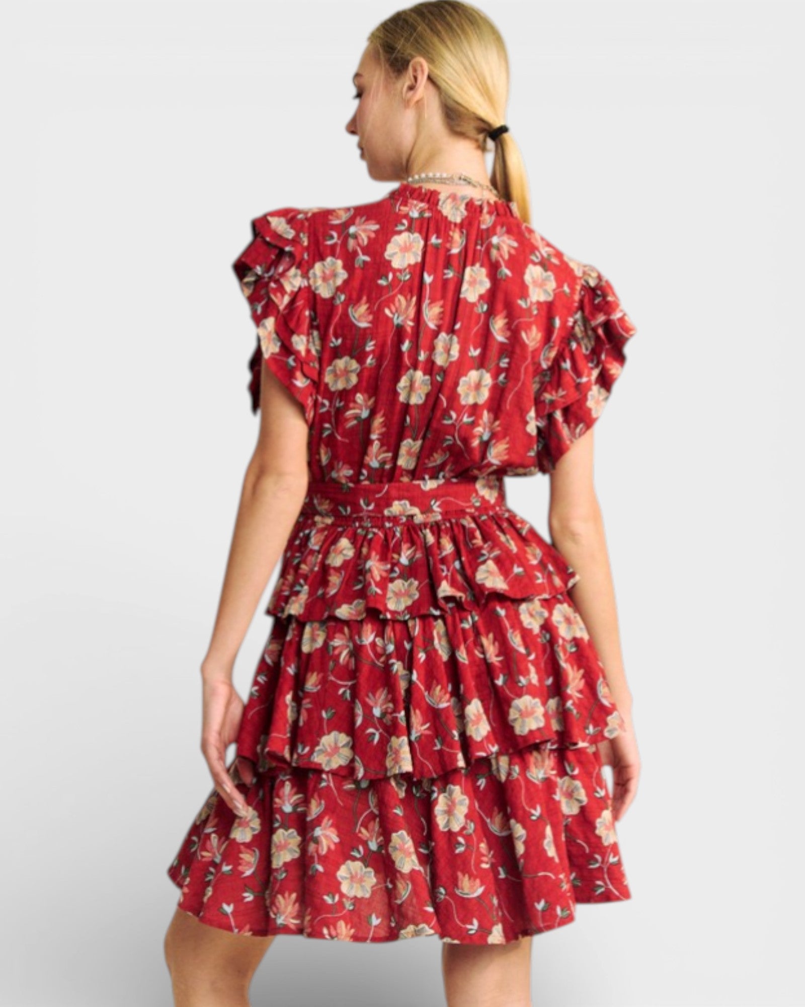 Woman wearing a red floral dress on a white background