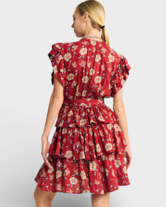 Woman wearing a red floral dress on a white background