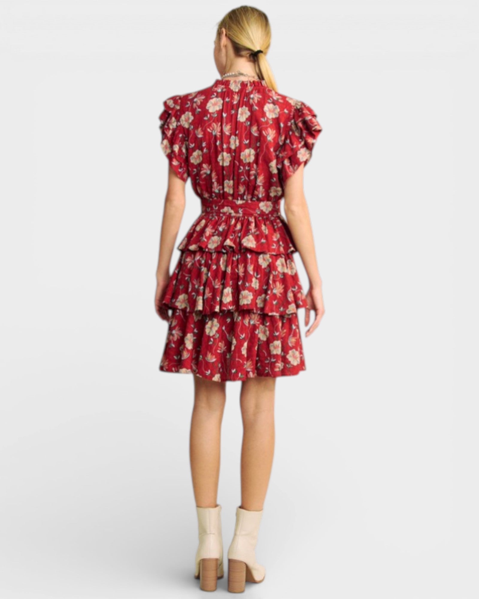 Woman wearing a red floral dress on a white background