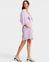 Woman wearing a light purple dress with a white background