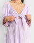 Lavender dress with a knot detail on a plain background