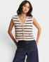 Woman wearing a striped vest and jeans on a white background