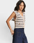 Woman wearing a striped sleeveless top and jeans on a white background