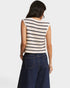 Woman wearing a striped sleeveless top and dark jeans on a white background
