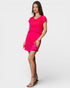 Woman wearing a bright pink dress on a white background