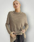 Woman wearing a brown turtleneck sweater against a plain background