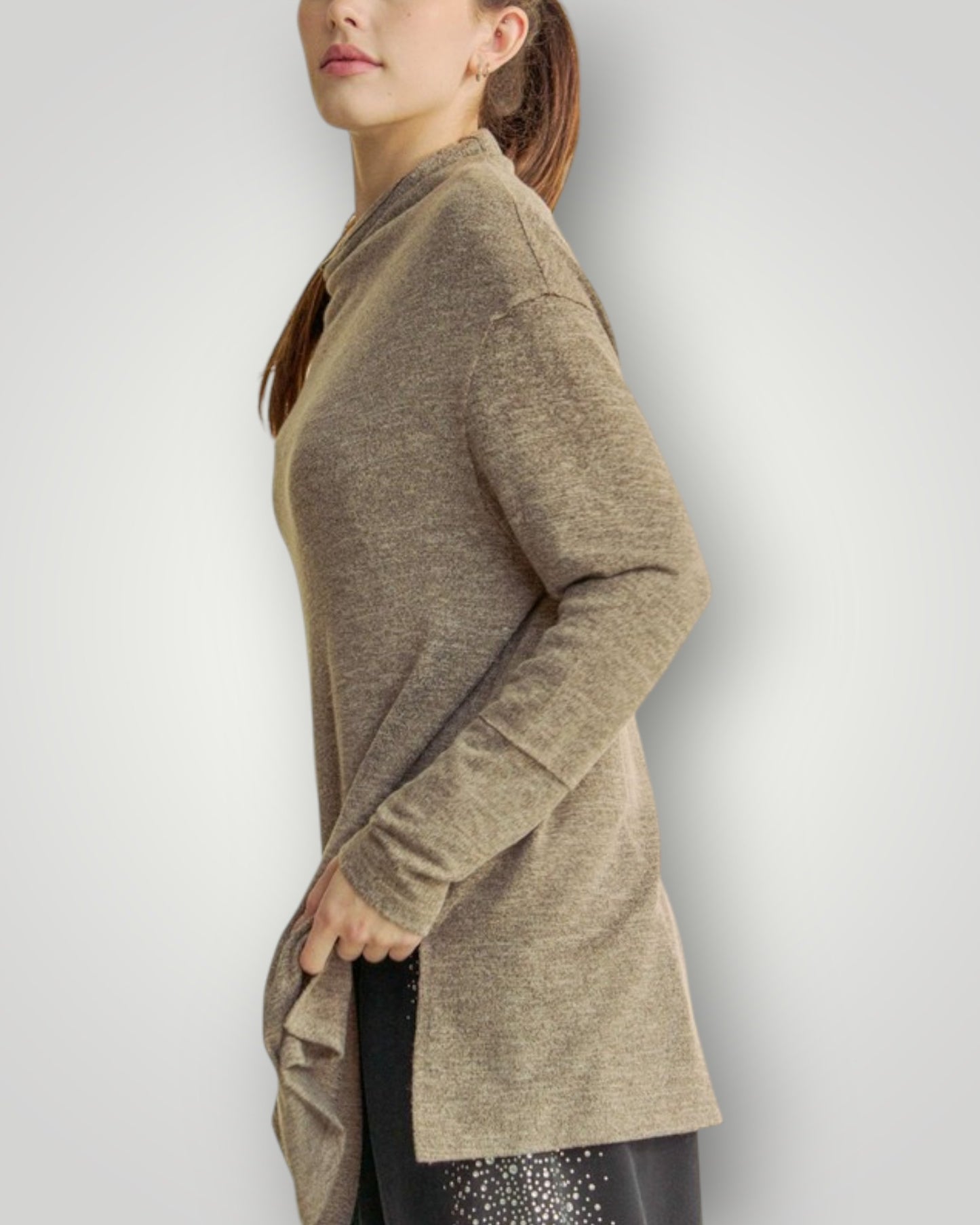 Woman wearing a beige cardigan against a plain background
