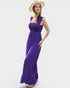 Woman wearing a purple dress and straw hat on a white background