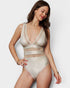 Woman wearing a beige mesh bodysuit against a plain background