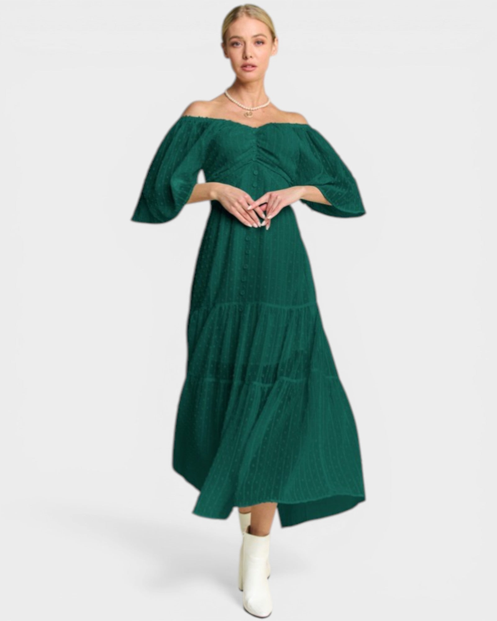 Woman wearing a green off-shoulder dress on a white background