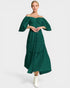 Woman wearing a green off-shoulder dress on a white background