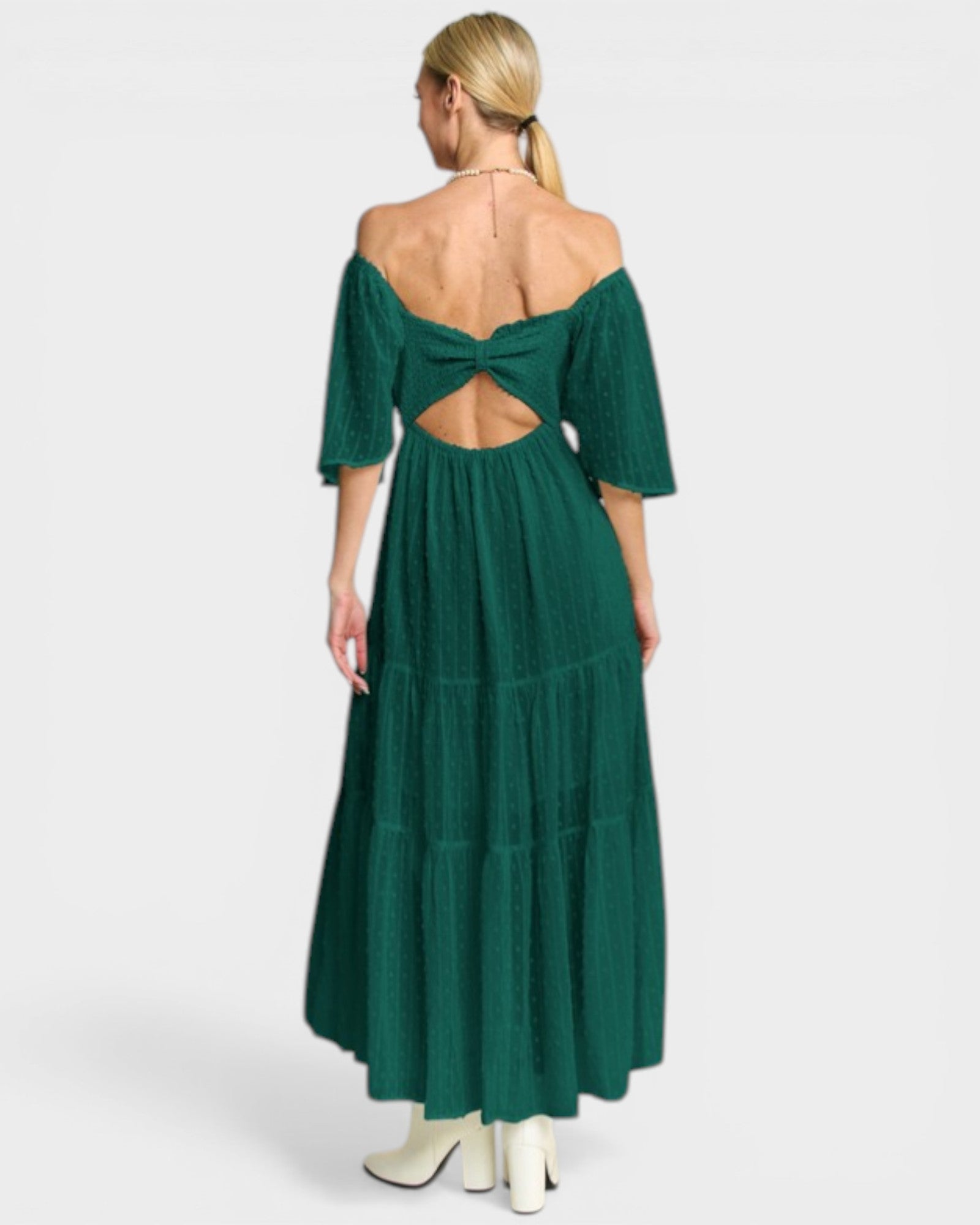 Green off-shoulder dress with cut-out back on a white background
