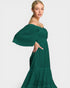 Woman wearing a green dress with puffed sleeves on a white background