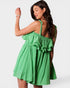 Woman wearing a green checkered dress against a white background