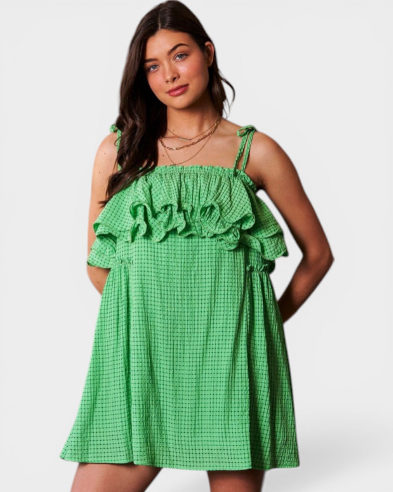 Woman wearing a green checkered dress on a white background