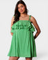 Woman wearing a green checkered dress on a white background