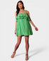 Woman wearing a green checkered dress on a white background