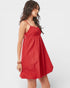 Woman wearing a red dress on a white background