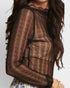 Black sheer long-sleeve top worn by a person with long dark hair on a light gray background.