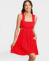 Woman wearing a red dress with cut-out design on a white background