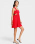 Woman wearing a red dress with cut-out design on a white background