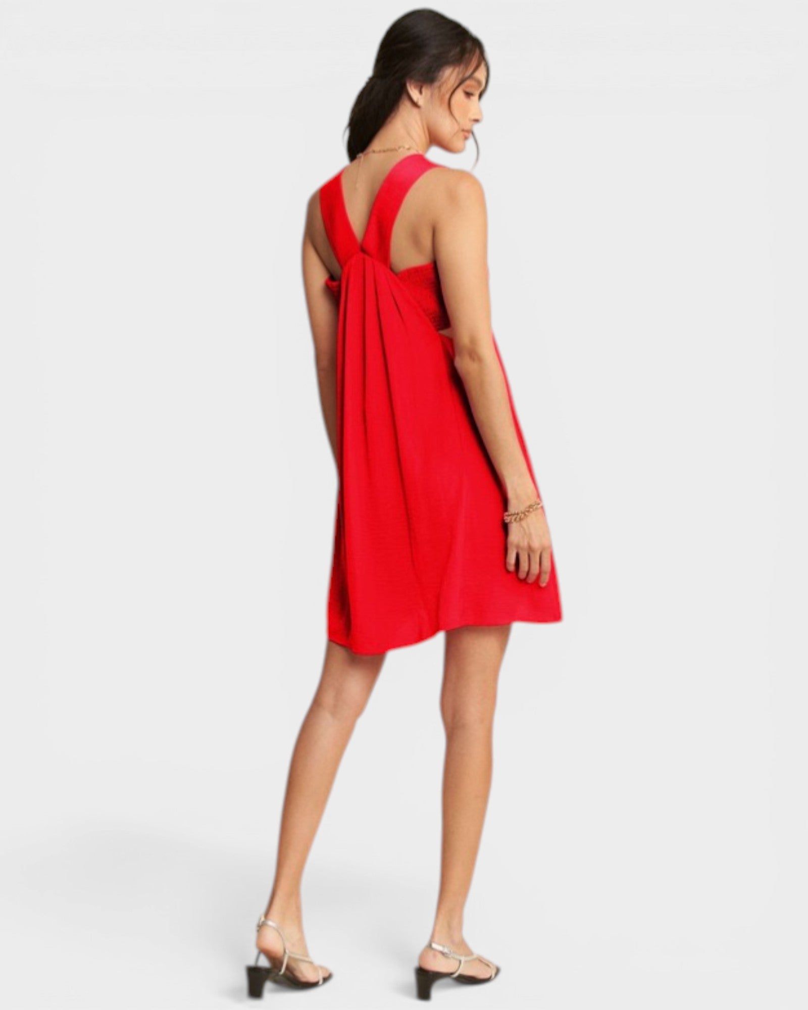 Woman wearing a red dress with a white background
