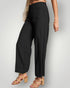 Person wearing black high-waisted pants on a plain background