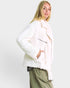 Woman wearing a white fur coat against a plain background