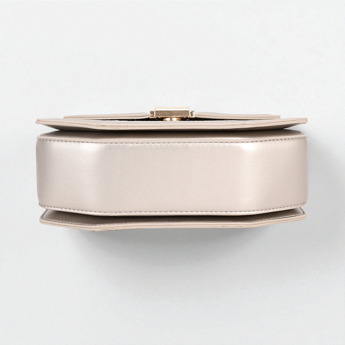 Round metallic object on a white background