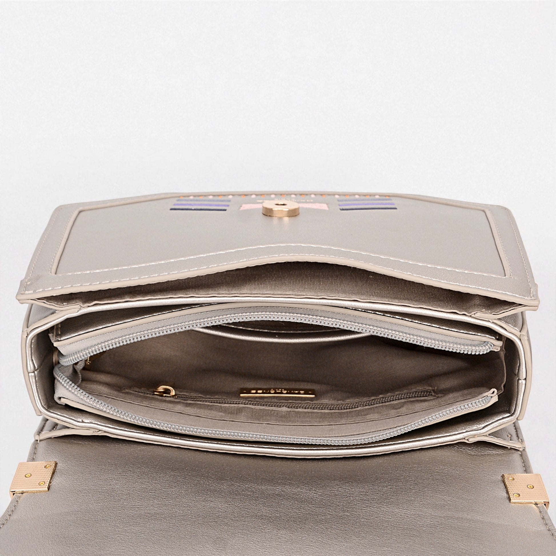 Silver handbag with gold accents on a light gray background