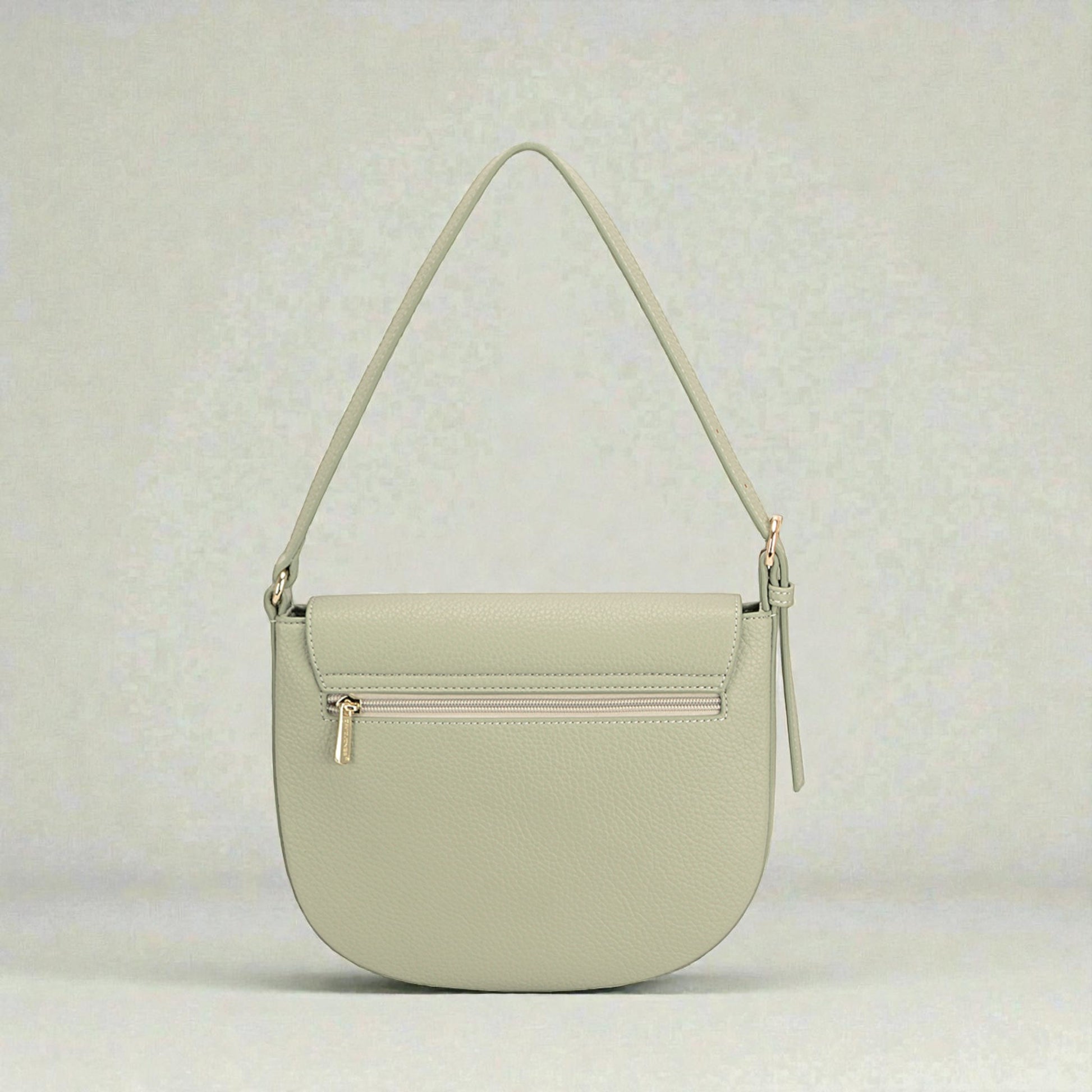 Light green handbag with a strap on a light gray background