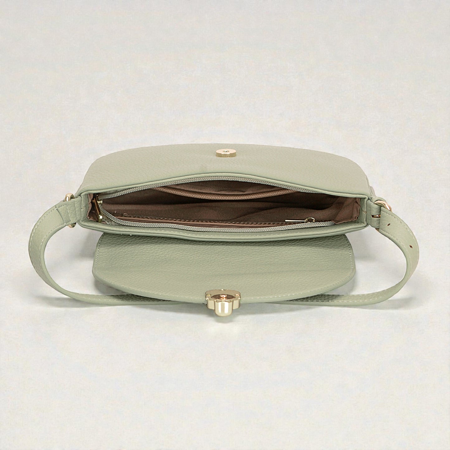 Light green handbag with gold clasp on a white background