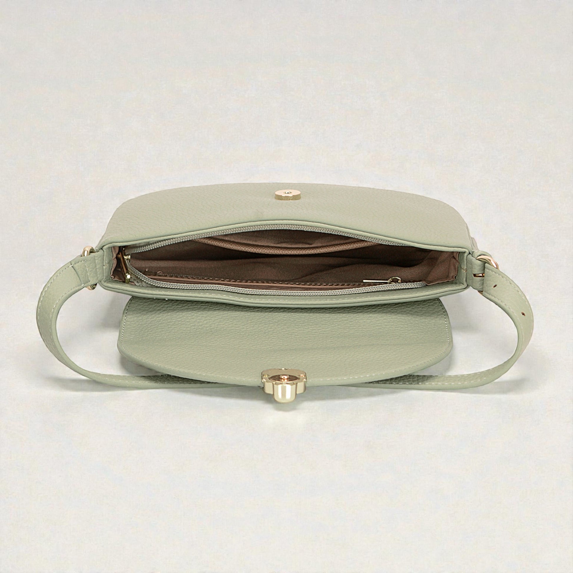 Light green handbag with gold clasp on a white background