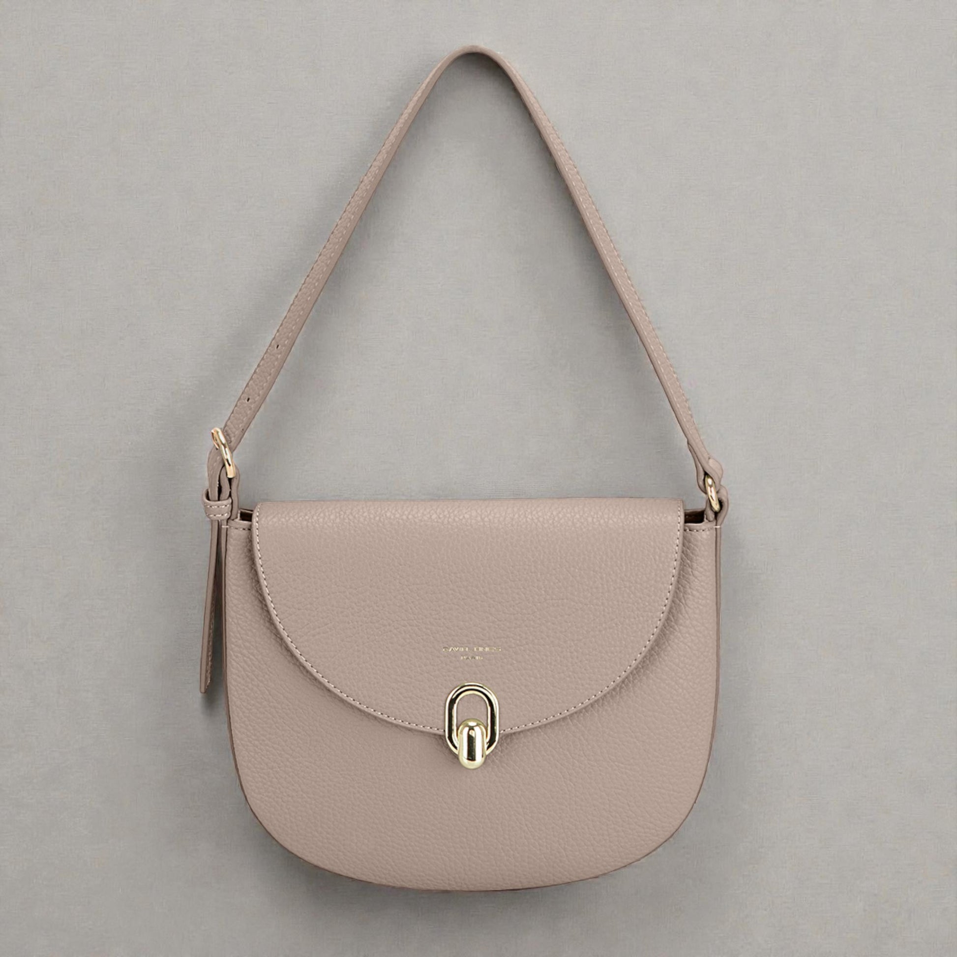 Beige handbag with a gold clasp on a gray background