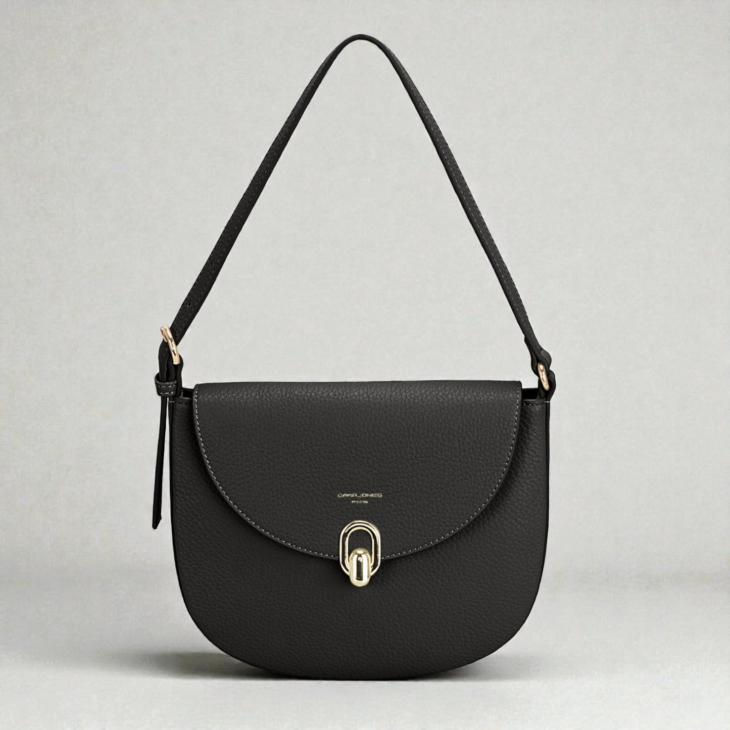Black handbag with a gold clasp on a light gray background