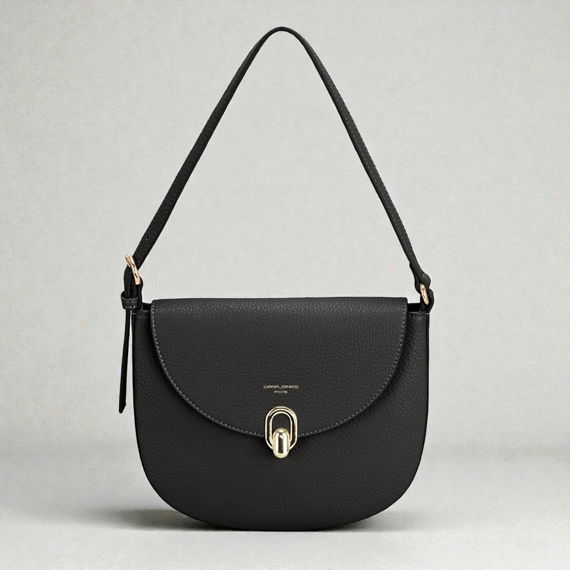 Black handbag with a gold clasp on a light gray background