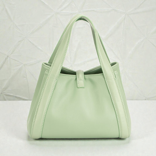 Mint green handbag on a light gray background