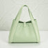Mint green handbag on a light gray background