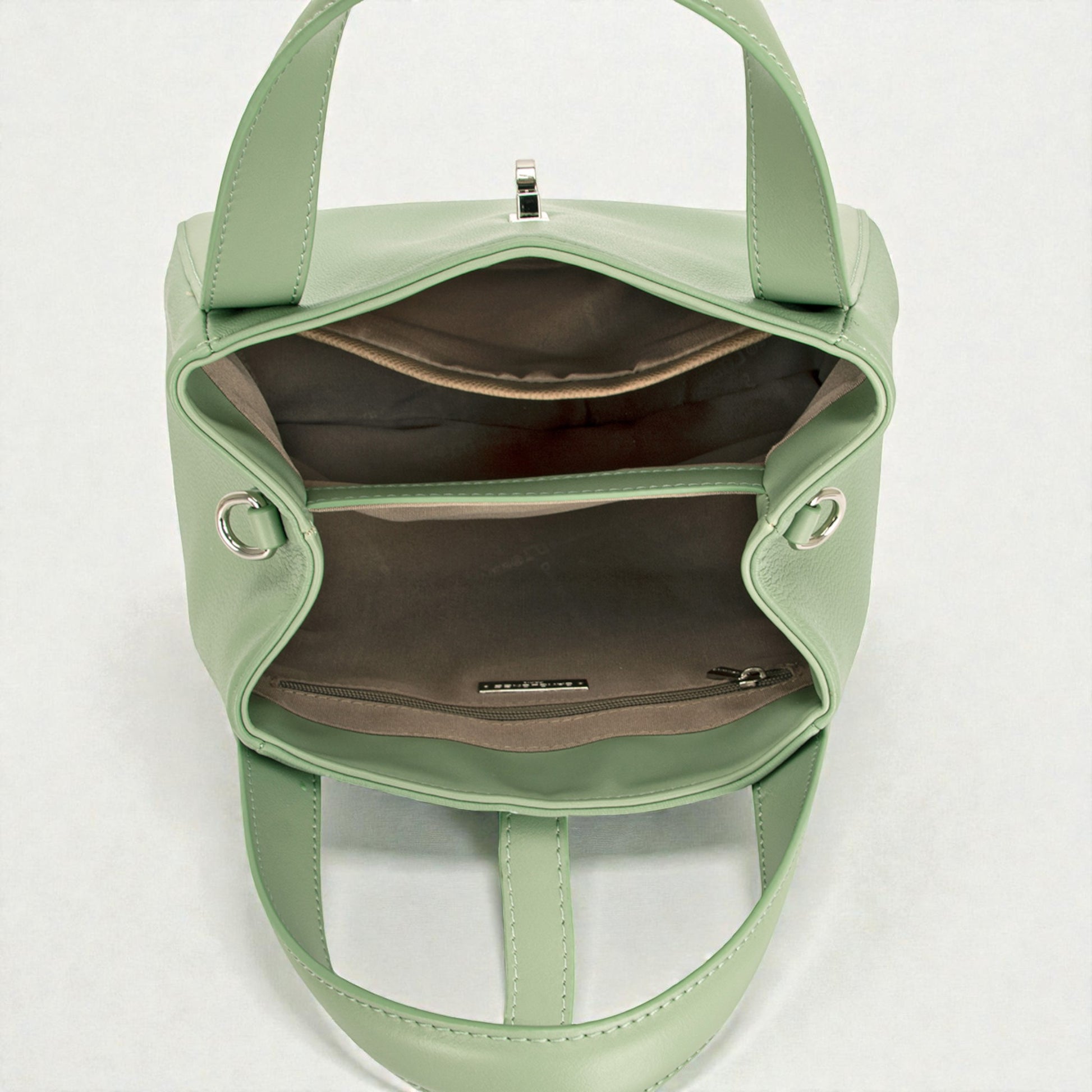 Green handbag with open front pocket on a white background