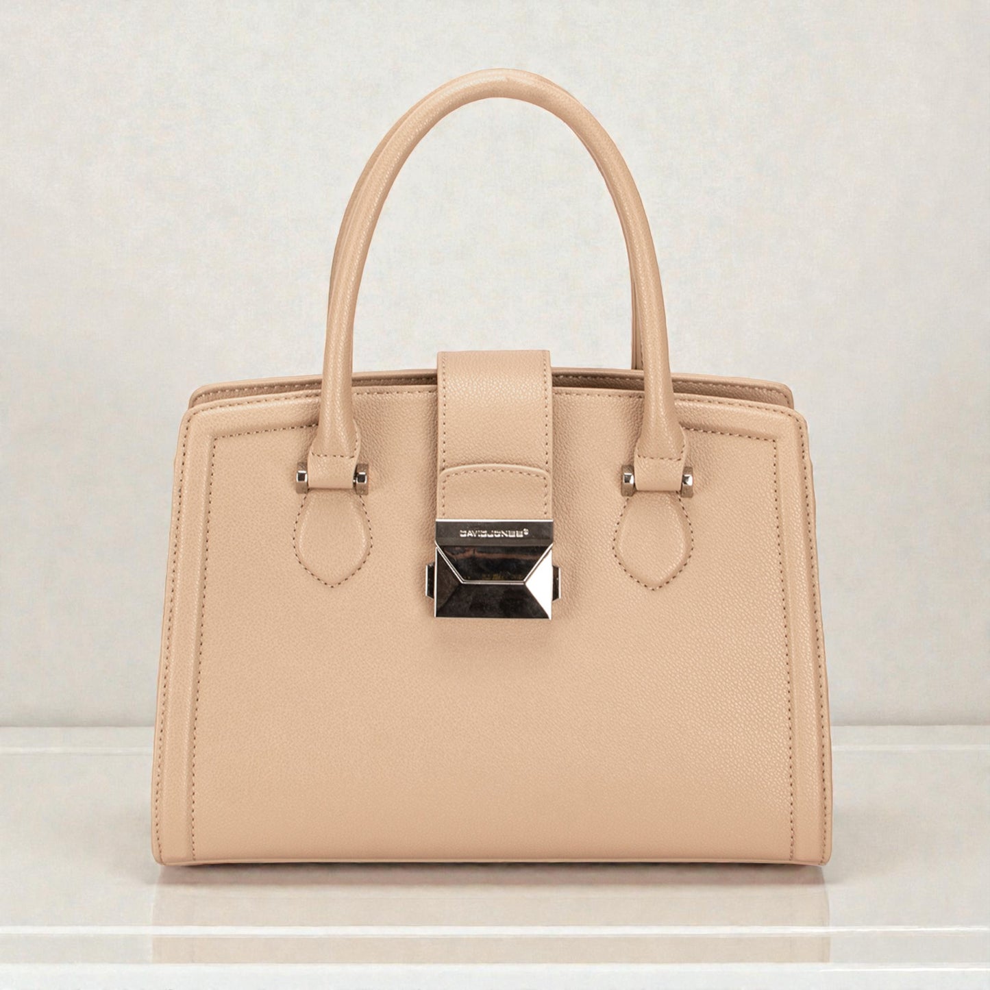 Beige handbag with a brand logo on a light gray background