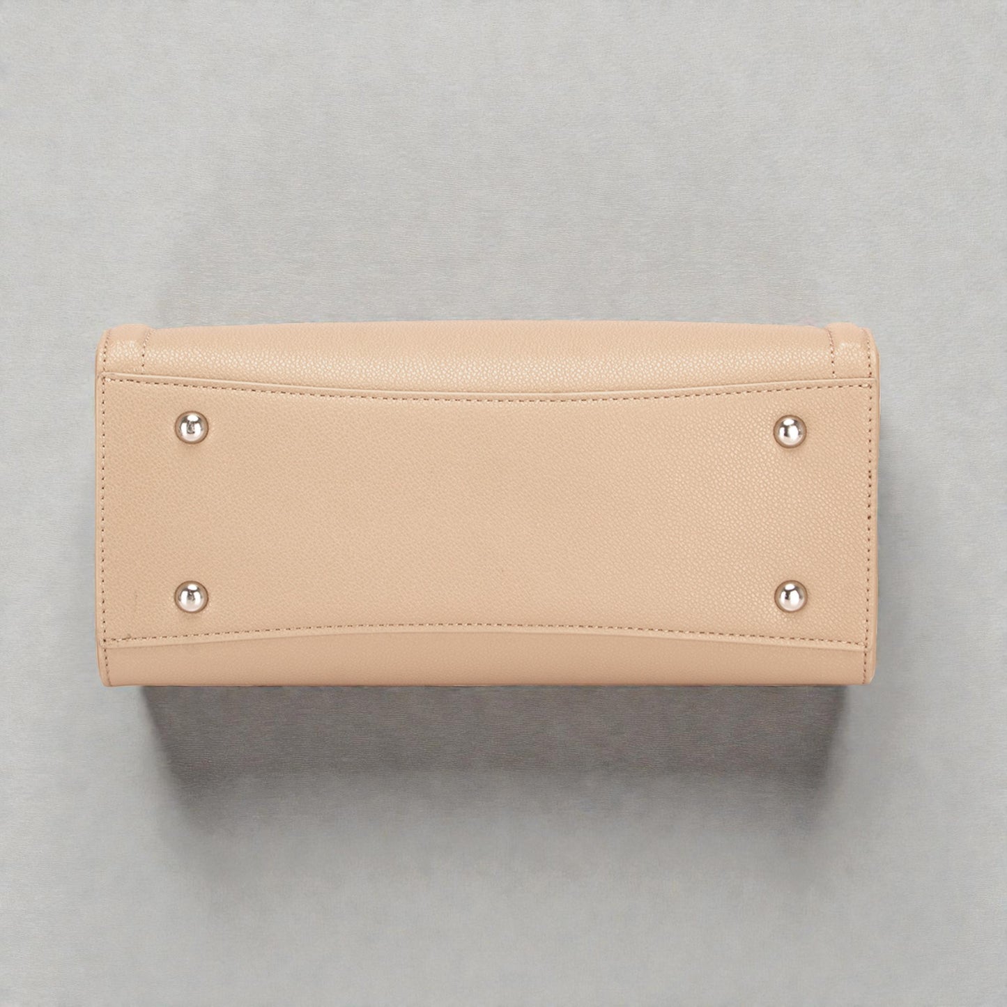Beige wallet with silver studs on a gray background