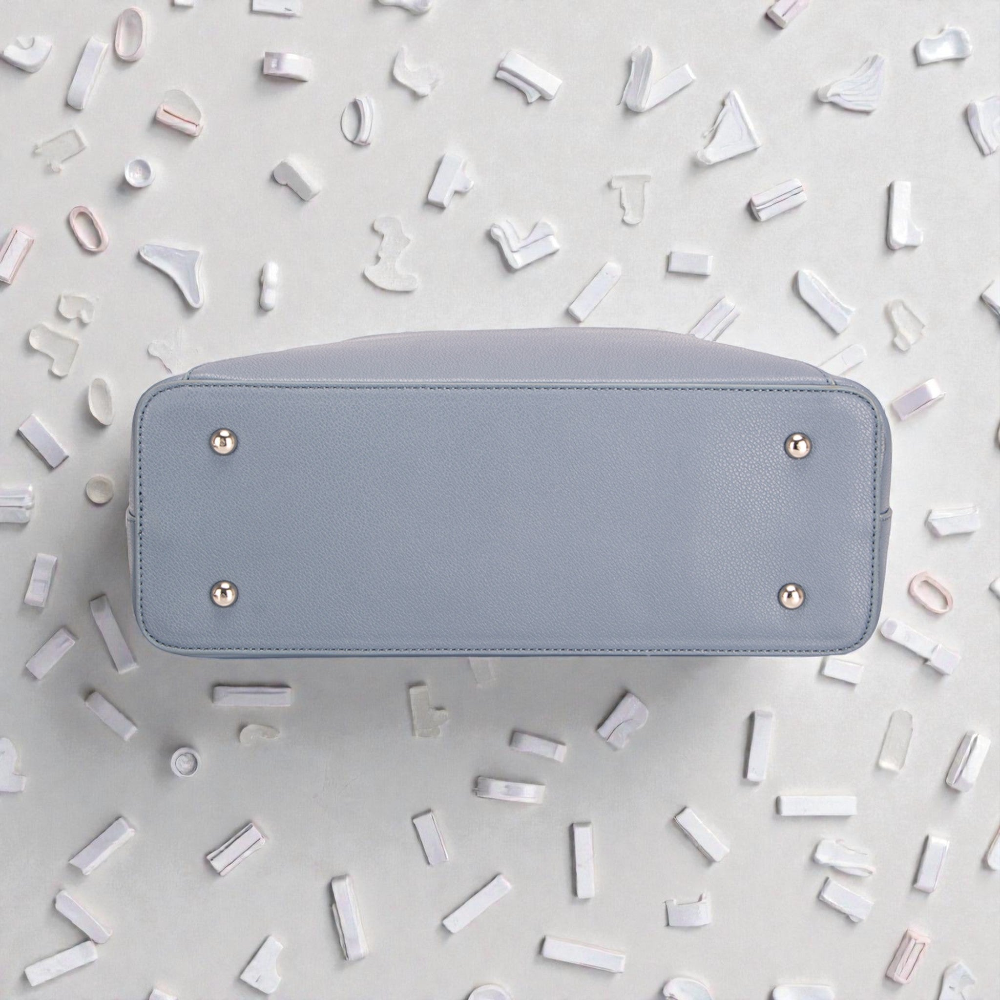 Light blue wallet on a light gray background with decorative elements